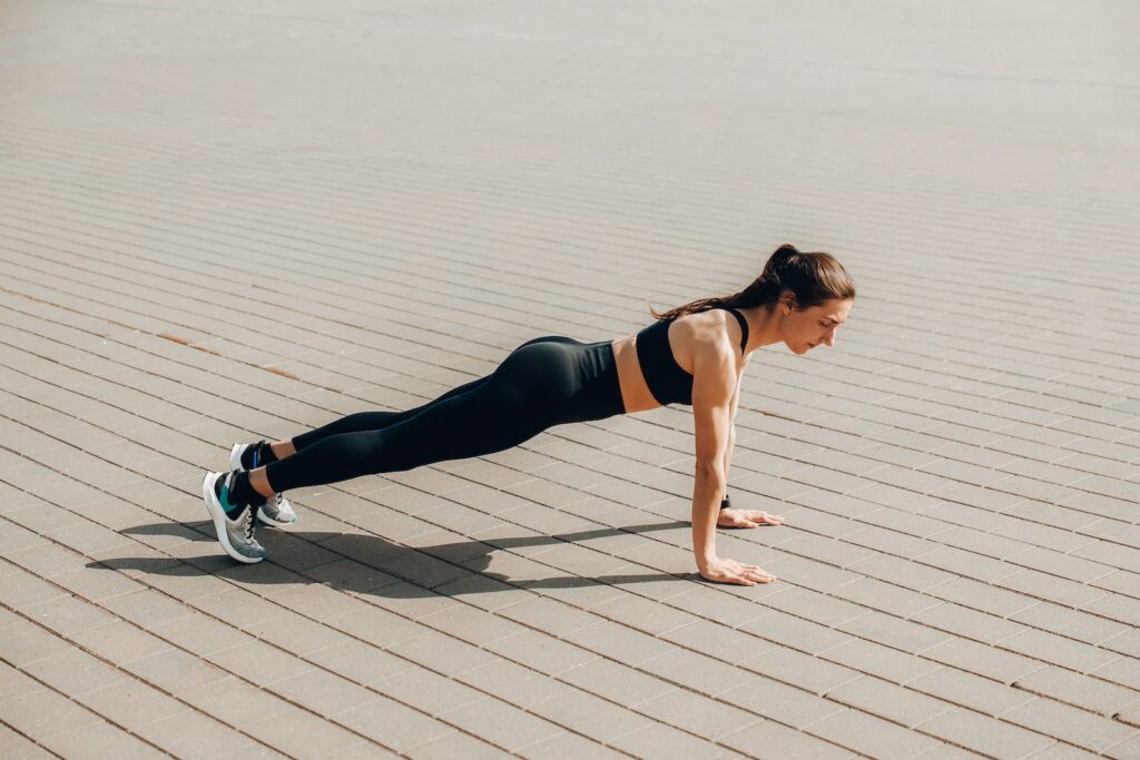 A Woman in Activewear Doing a Push Up