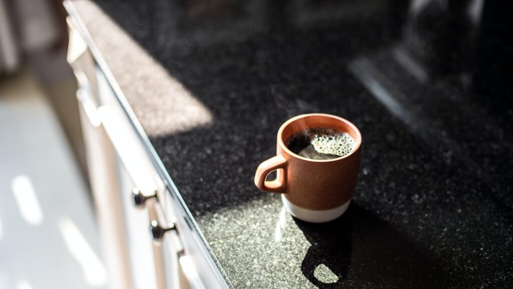 brown and white ceramic mug on table