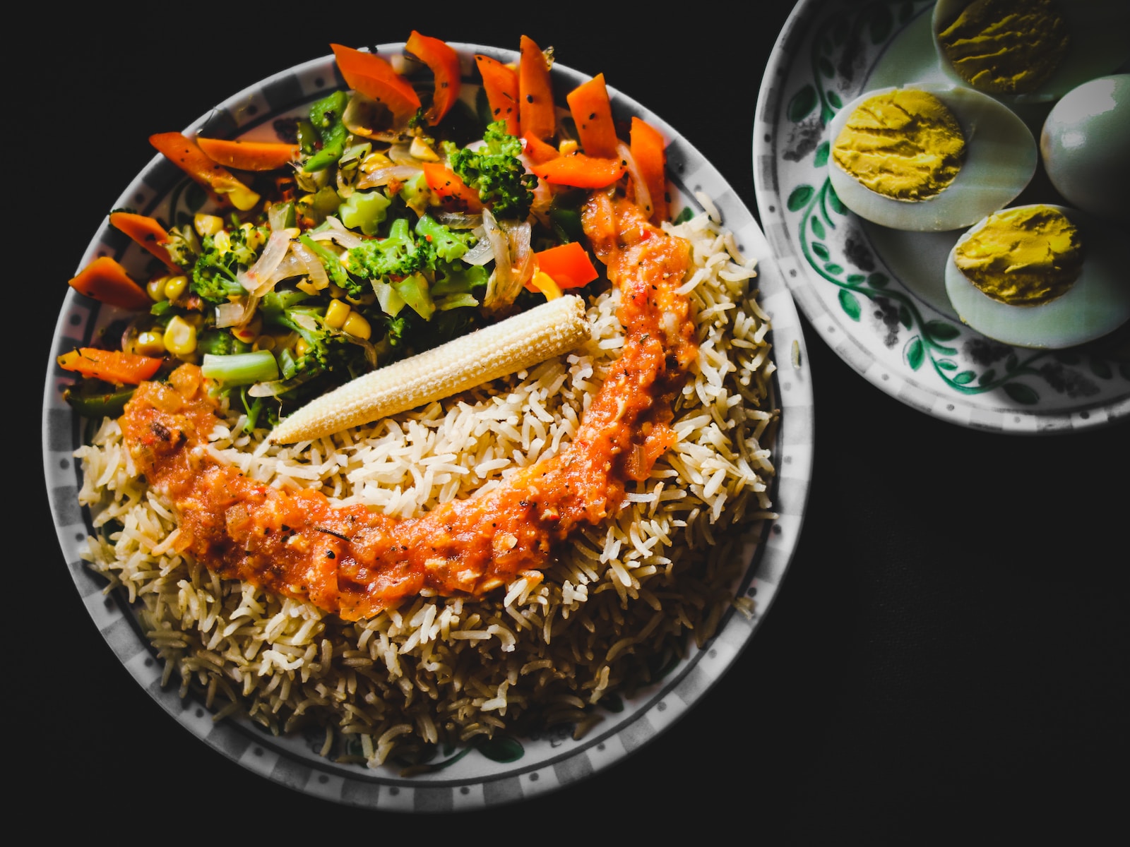 rice with sliced lemon and green leaf vegetable on white ceramic plate