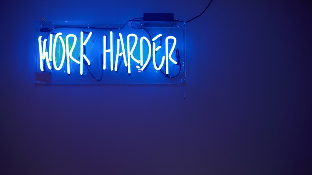 blue Work Harder neon signage