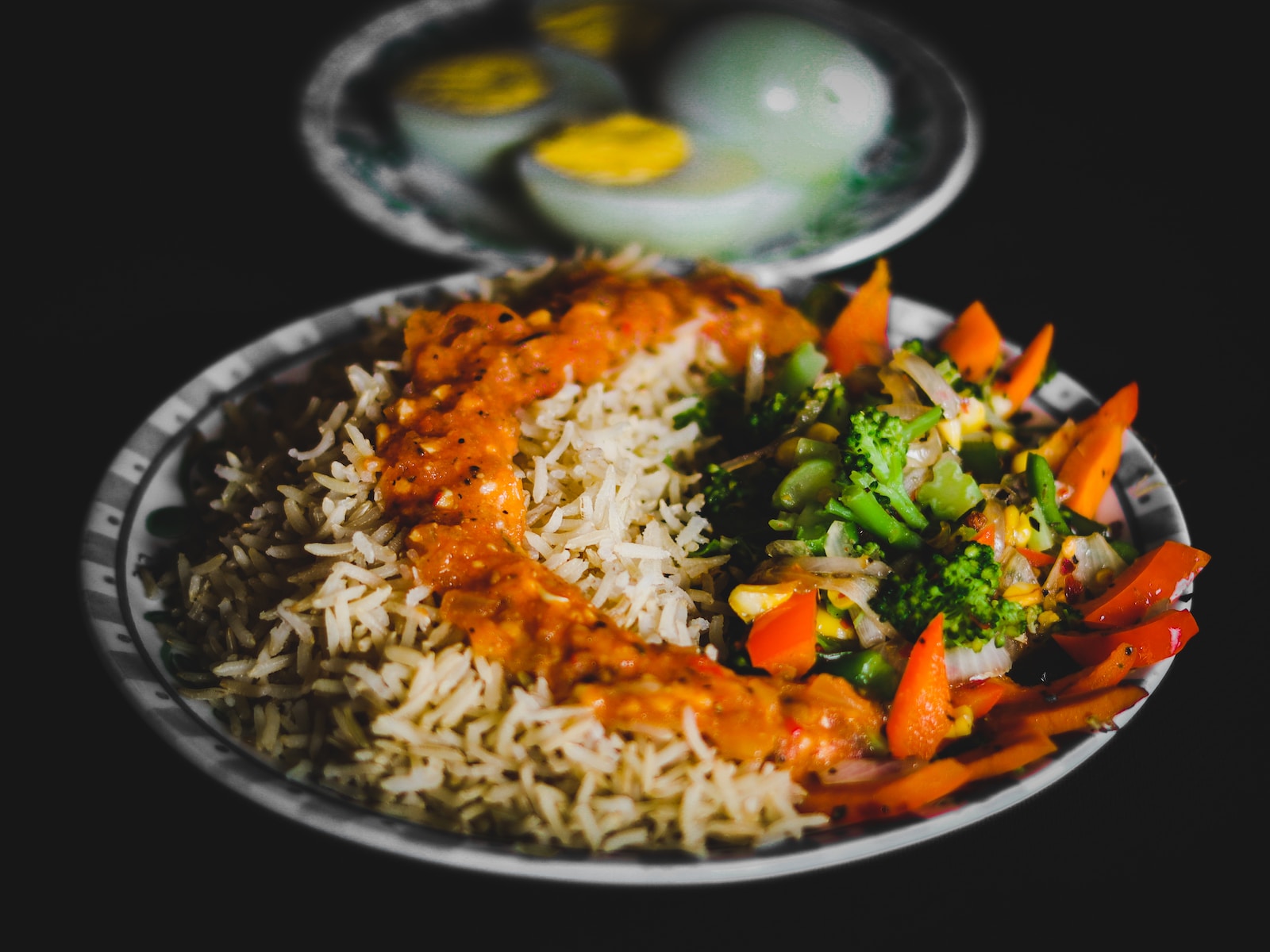 rice with sliced lemon and green vegetable on plate